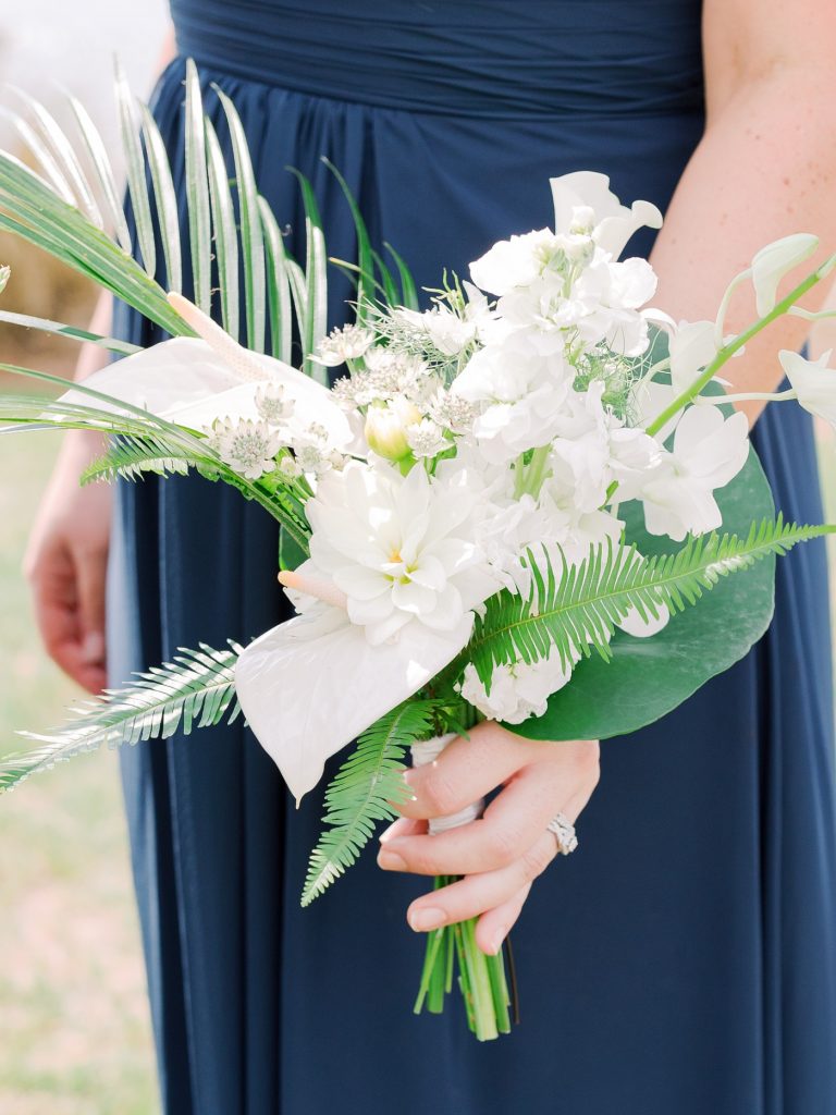 Bridesmaids bouquets with palm leaves, ferns, dahlias and ranunculus