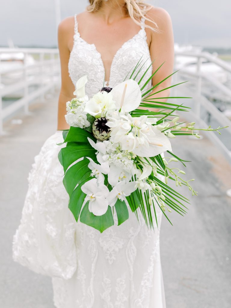 Bridal bouquet with palm leaves, orchids, anthurium and dahlias