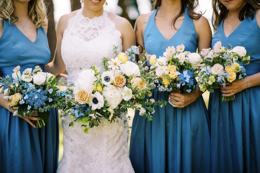 Bridal bouquet with Panda anemones, peonies, delphinium, scabiosa, and seasonal blooms by Gray Harper Florist