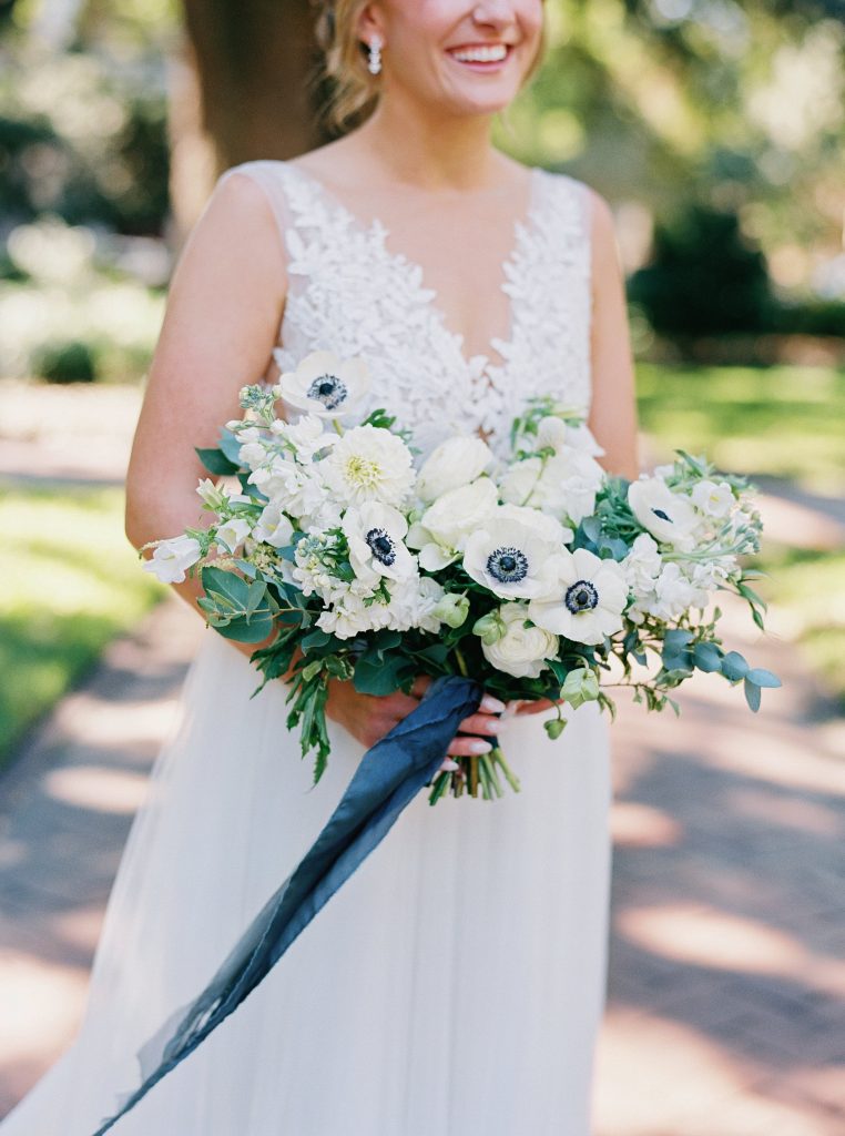 Savannah bride holding wedding bouquet with whit flowers