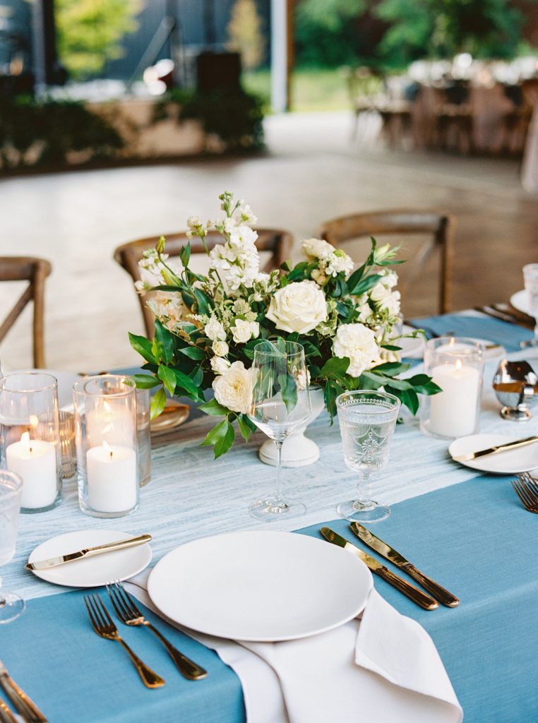 White wedding centrepiece with white and blue table decor