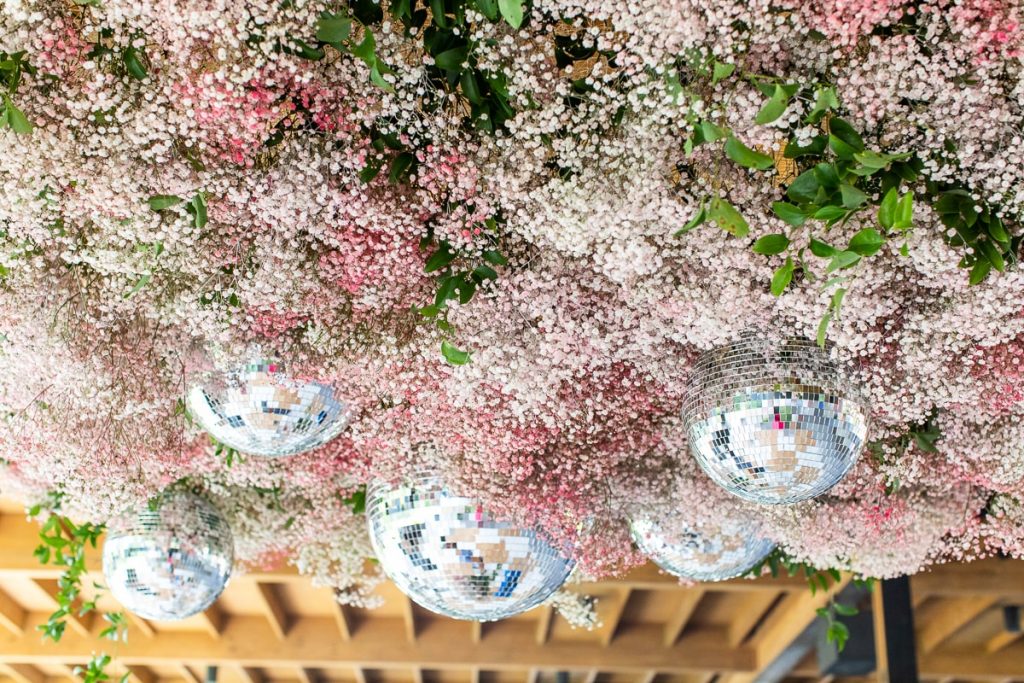 pink wedding floral installation above dance floor