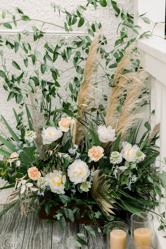 Floral arrangement with white and blue flowers and pampas grass
