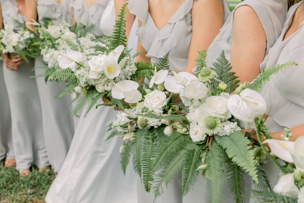 White bridesmaid bouquets with orchids and ferns
