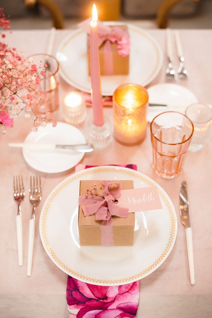 Pink table setting with pink flowers and pink candles