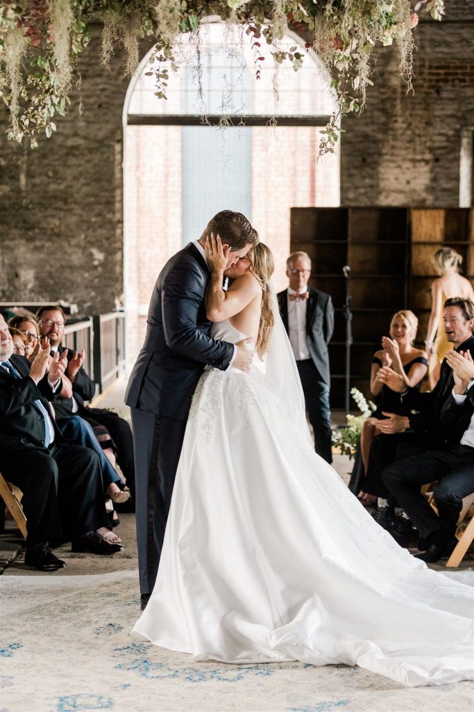 Memphis & Christmas kiss during wedding ceremony