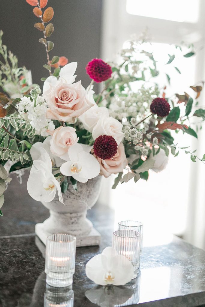 floral fall wedding arrangement with white, pink and burgundy flowers