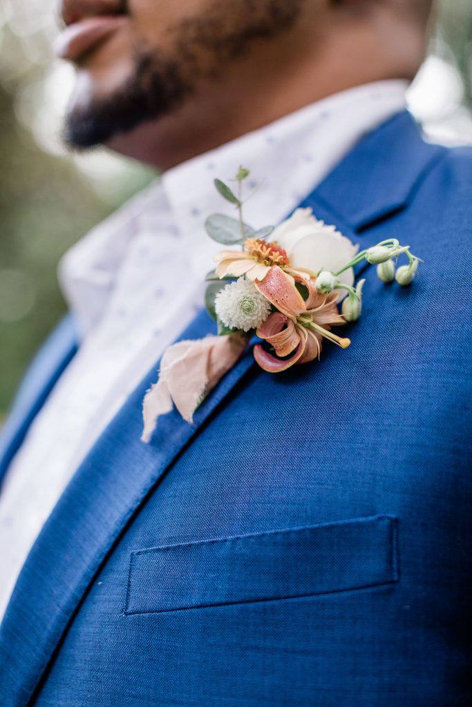 Grooms boutonnière with peach florals