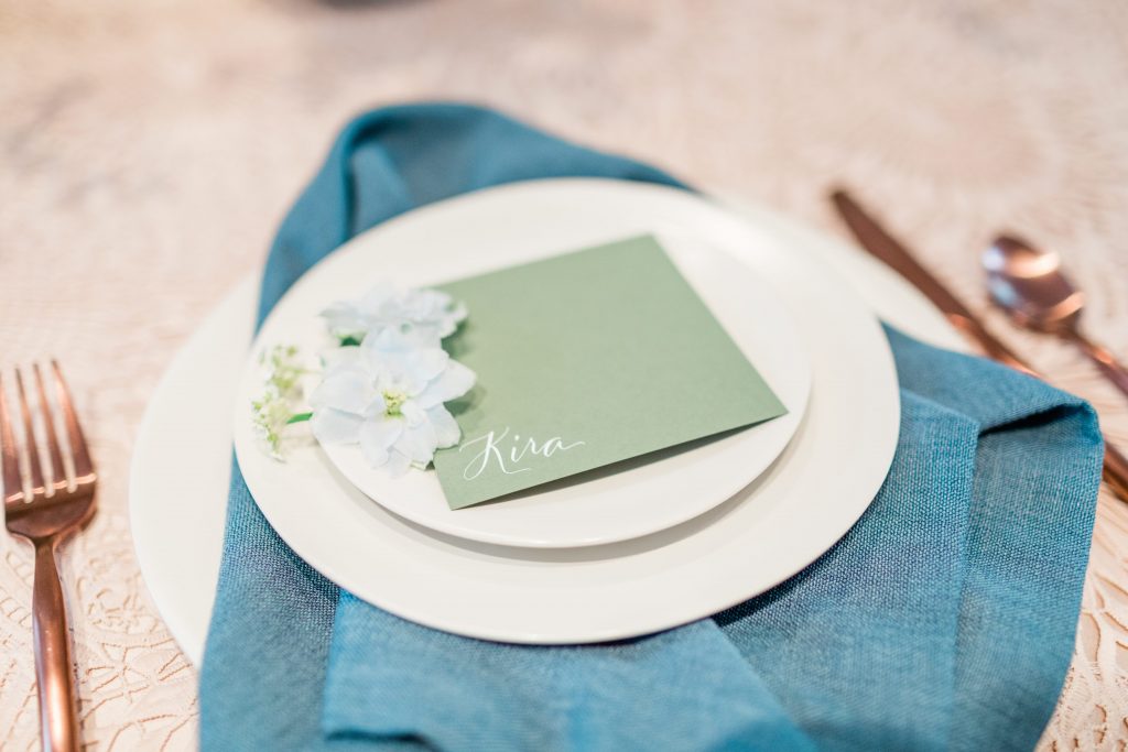 Wedding place setting with blue napkin