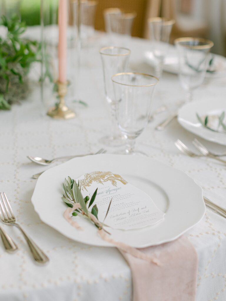 Fine art wedding place setting with rosemary sprig