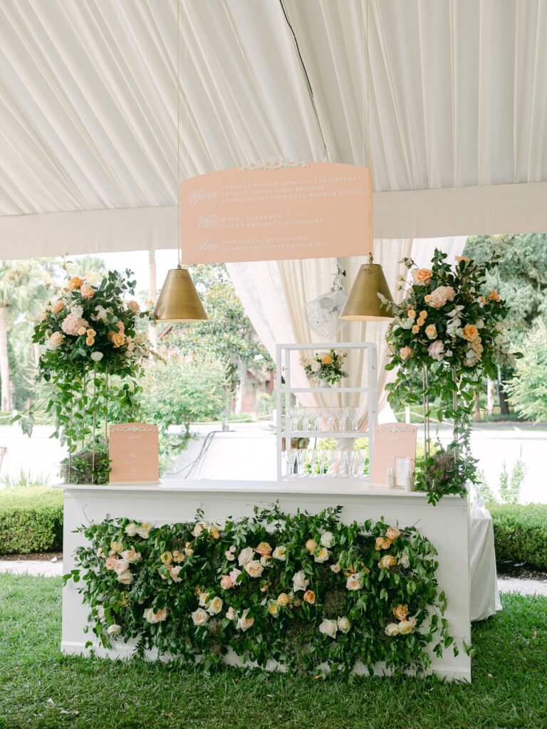 White & pink wedding bar with lush flowers