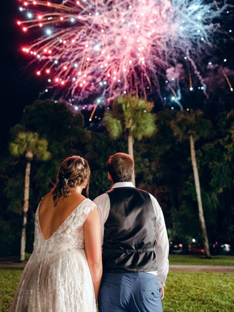 Bride and groom watching fireworks at wedding