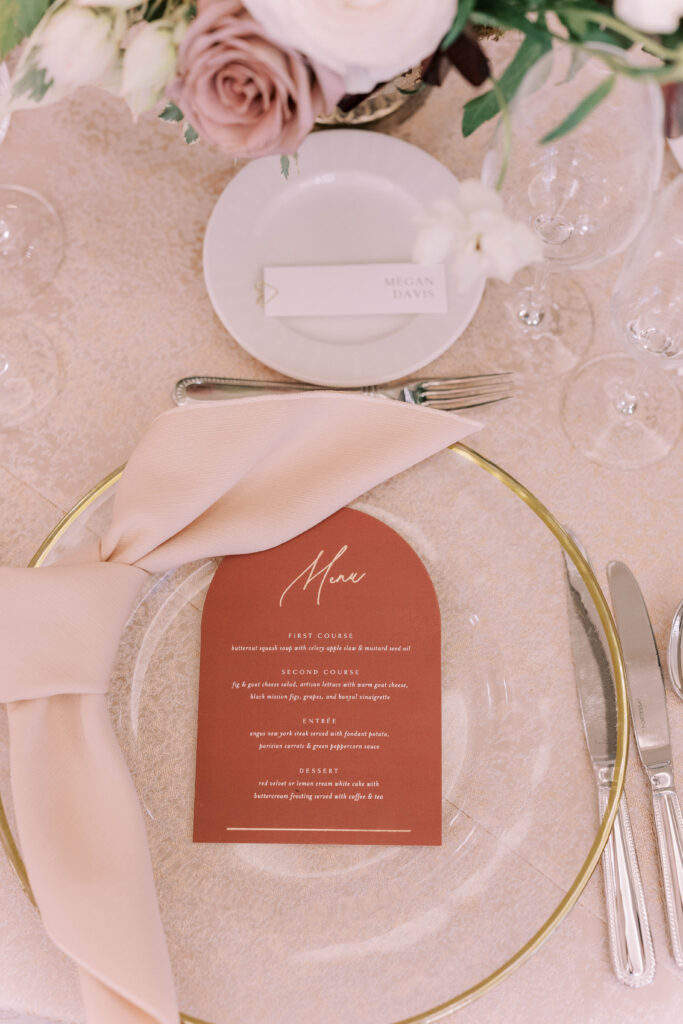 Wedding place setting with pink linen and pink menu