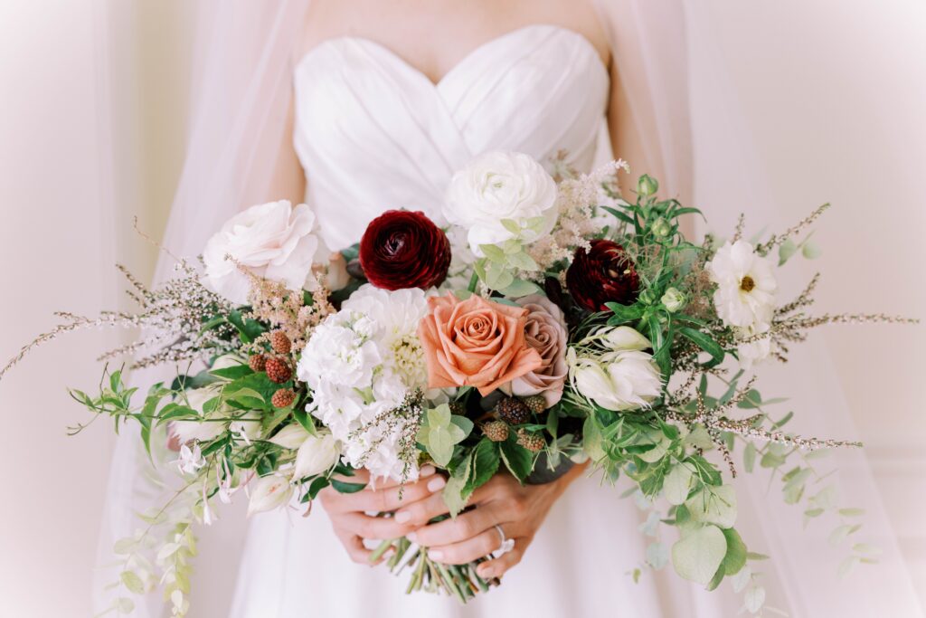 Textured bridal bouquet with white, mauve and burgundy flowers