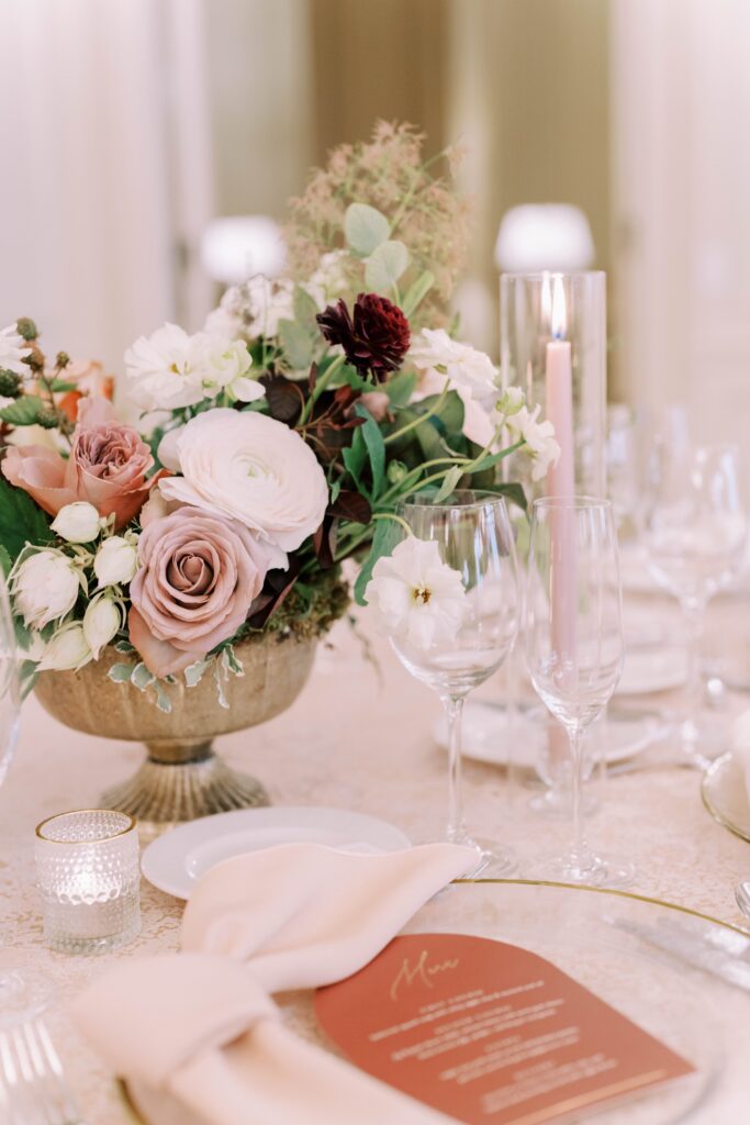 Floral wedding centrepiece with white, mauve and burgundy flowers