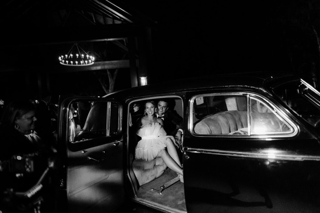 Bride and groom in vintage car