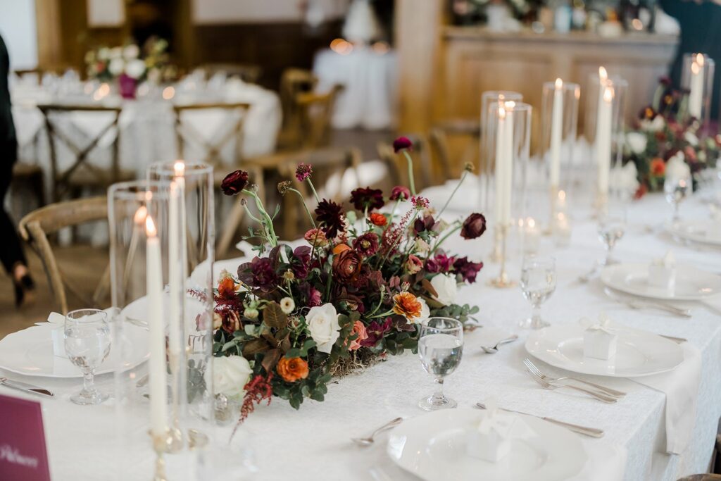 Wedding tables with burgundy centrepieces 
