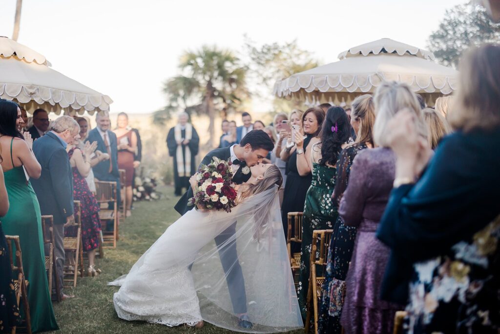 Bride kissing groom at Forbes Farm wedding ceremony