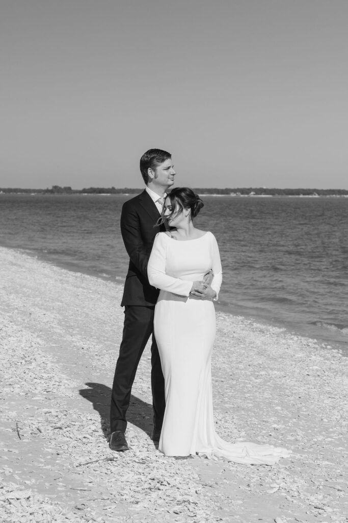 Black and white photo of bride and groom on the beach