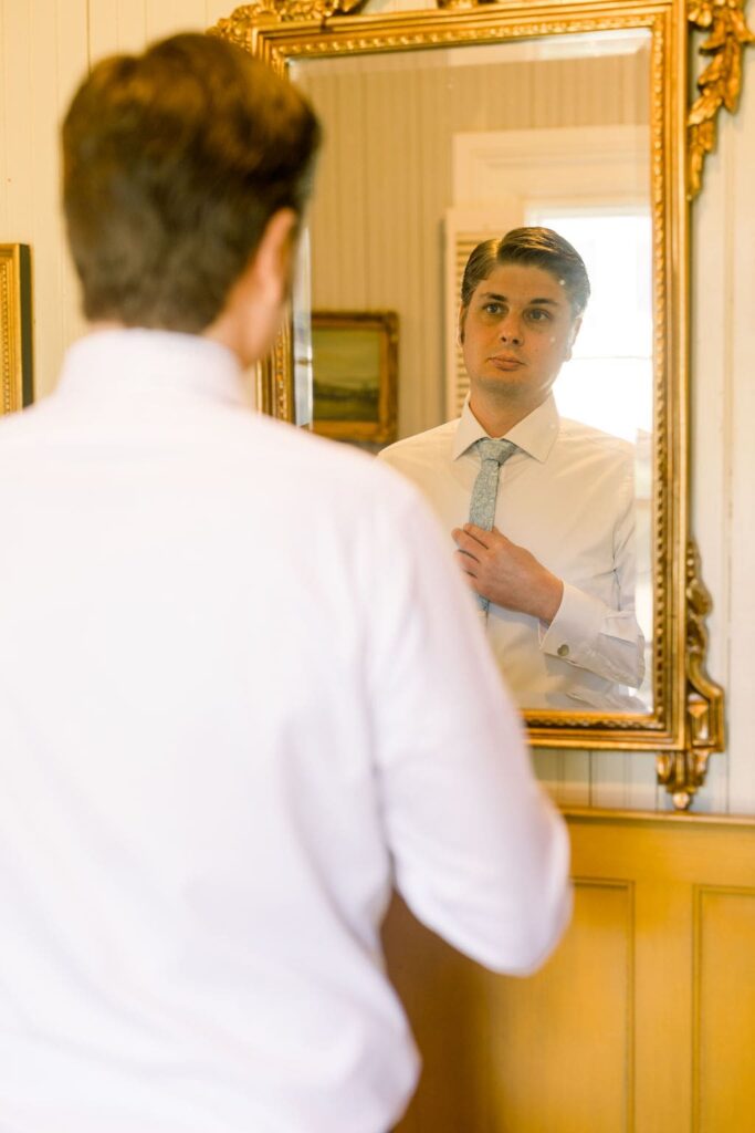 Groom getting ready in mirror