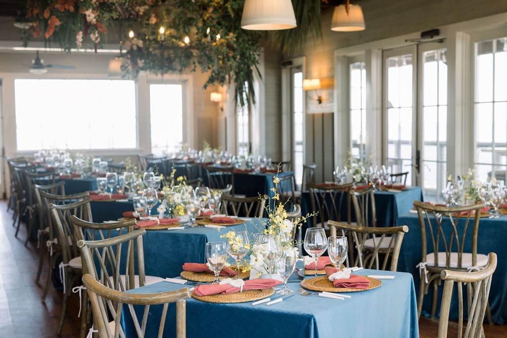 Haig Point wedding reception with blue tables and wood chairs