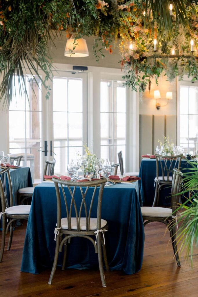 Haig Point wedding reception with blue tables and wood chairs