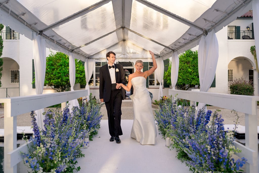 Bride and groom entering tent