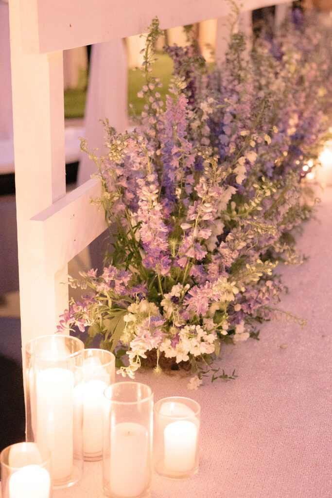 Blue delphinium flowers and candles
