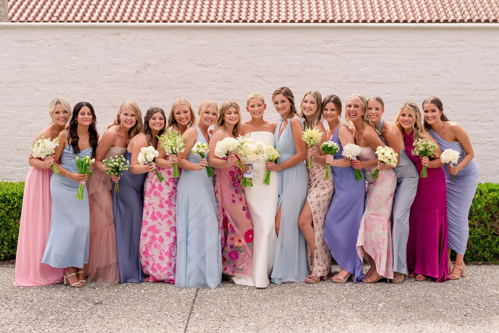 Bride with 14 bridesmaids in colorful dresses