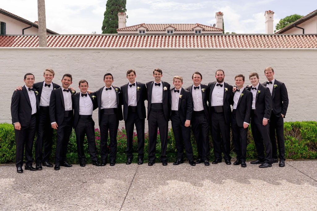 Groomsmen and groom in black tuxedos