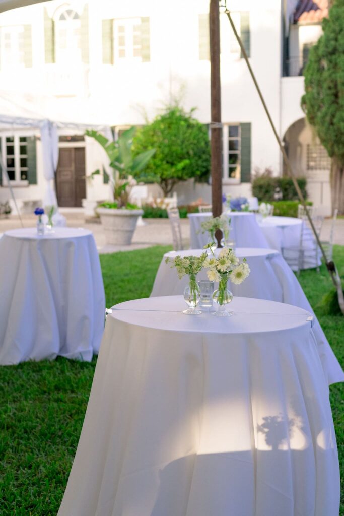 White cocktail tables with white flowers