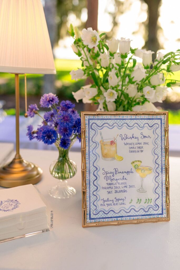 Blue & white flowers in vases with bar signage