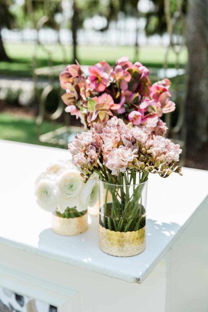 Mauve, blush and white flowers in gold vases