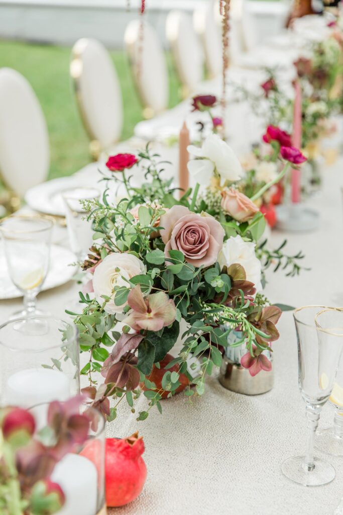 White wedding table with burgundy flower centrepiece 