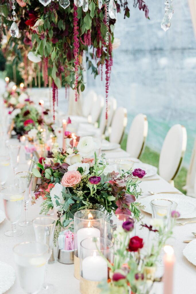 White wedding table with burgundy flowers 