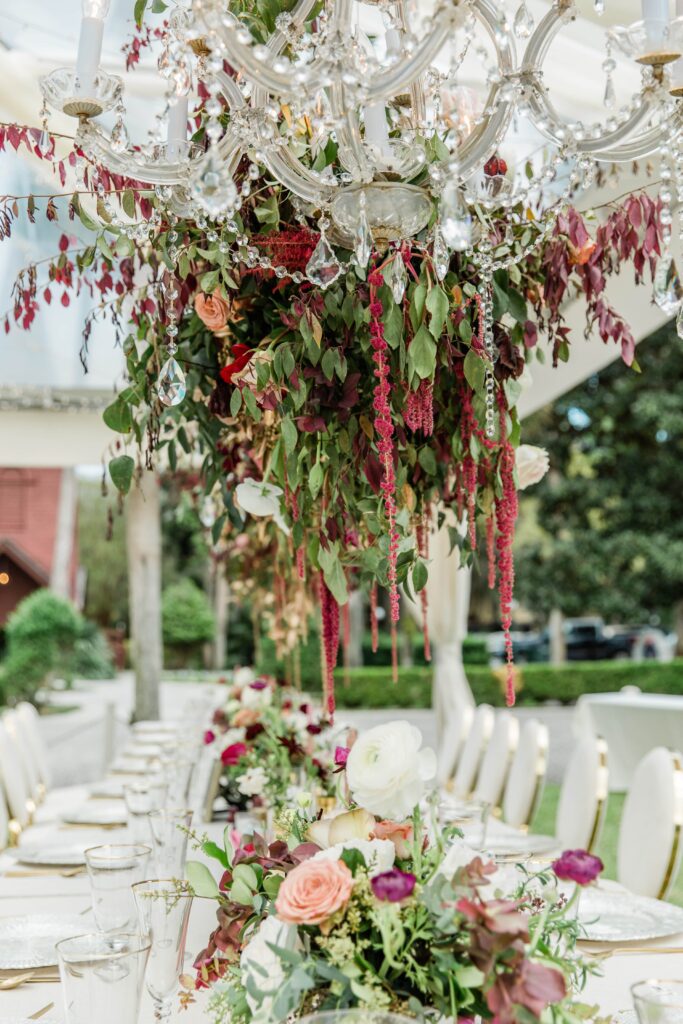 Hanging floral installation with chandeliers