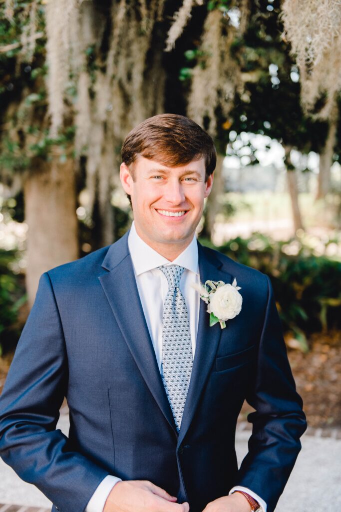 Groom in navy suit with pattern blue tie