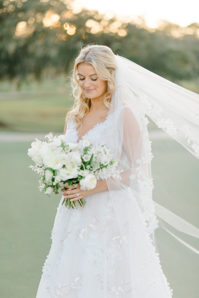 Bride in aline dress with white bridal bouquet