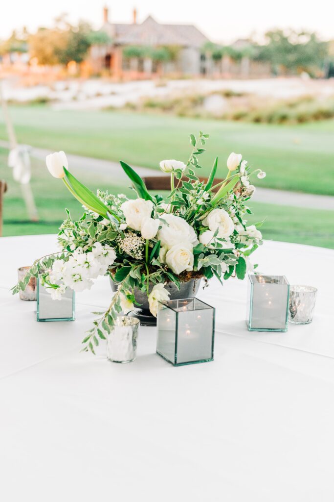 White floral centrepiece with silver votives