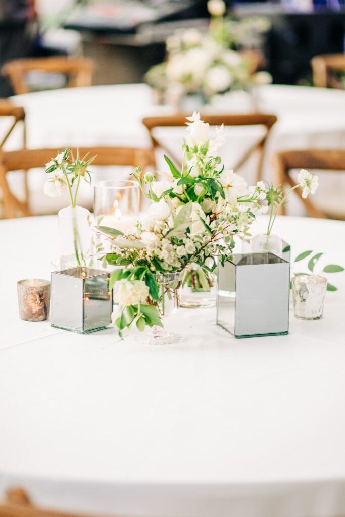 White floral centrepiece with silver votives