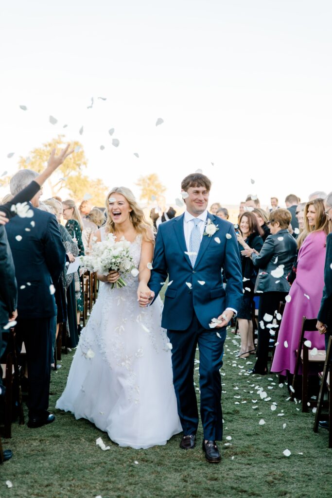 Bride and groom with flower petal exit at Colleton River Club wedding ceremony