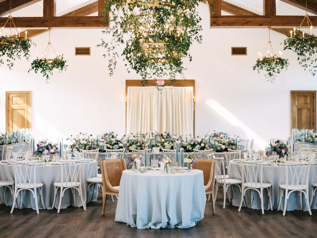 St. Simons Island Wedding reception with blue and white tables and greenery chandeliers