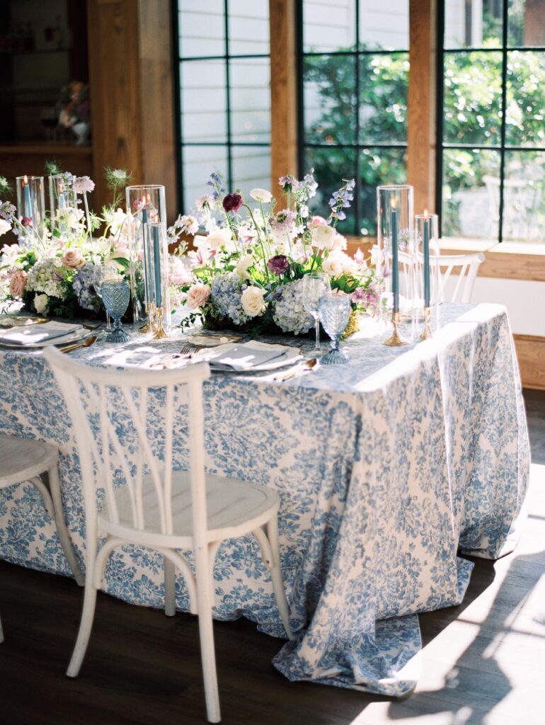 Blue and white wedding table with white wood chairs