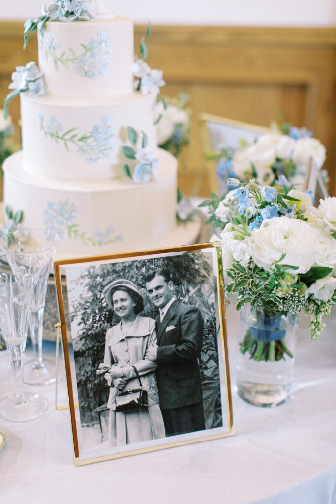 White and blue wedding cake with black and white vintage photo in front
