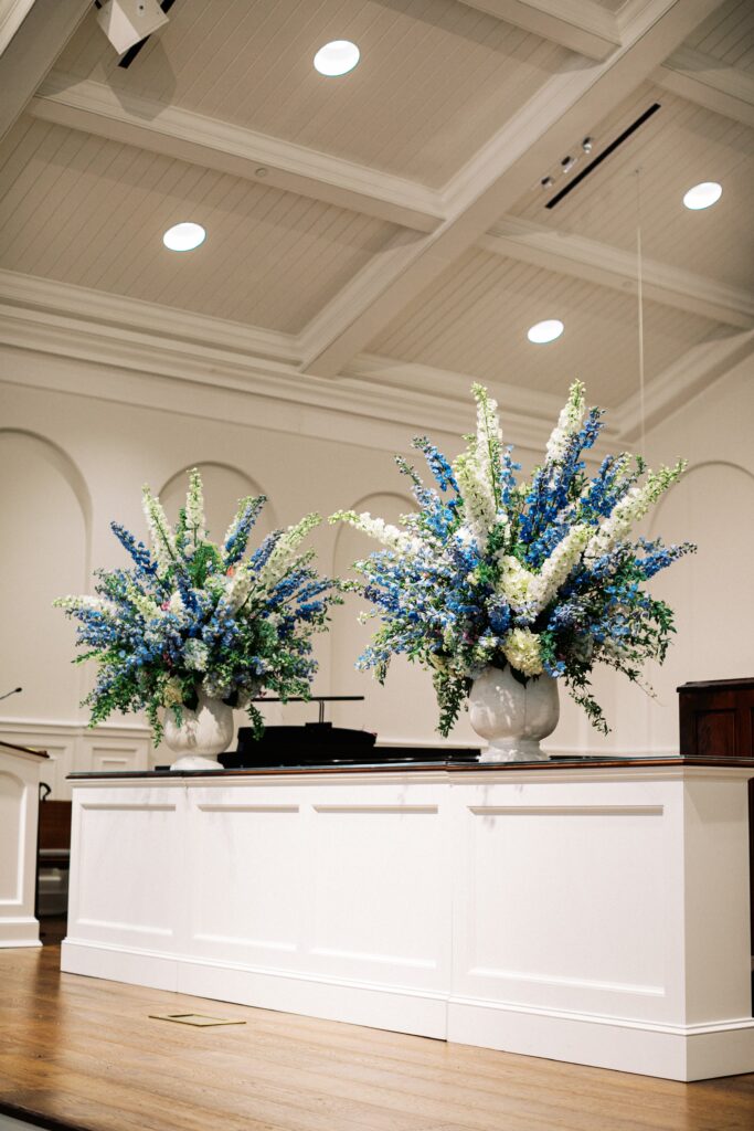 Large blue and white floral arrangements at church
