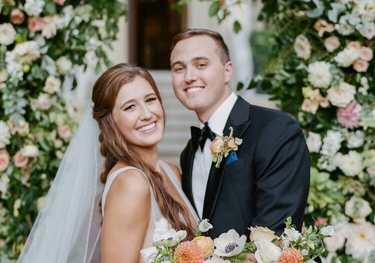 Savannah bride and groom with floral wedding ceremony arch