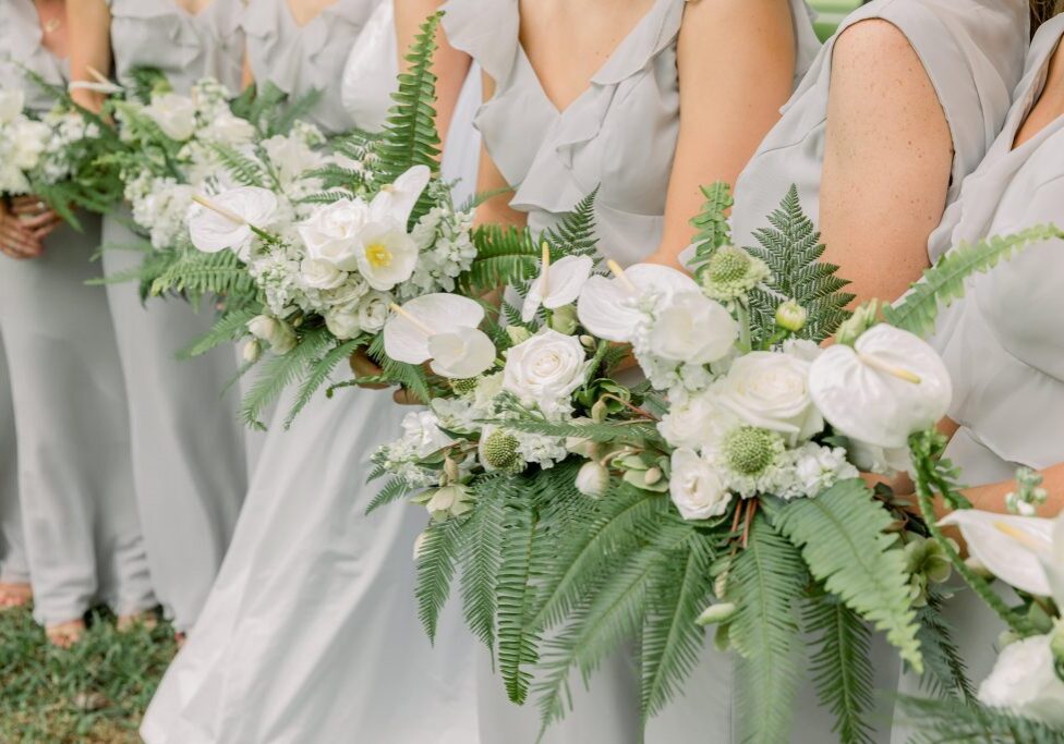 White bridesmaid bouquets with orchids and ferns